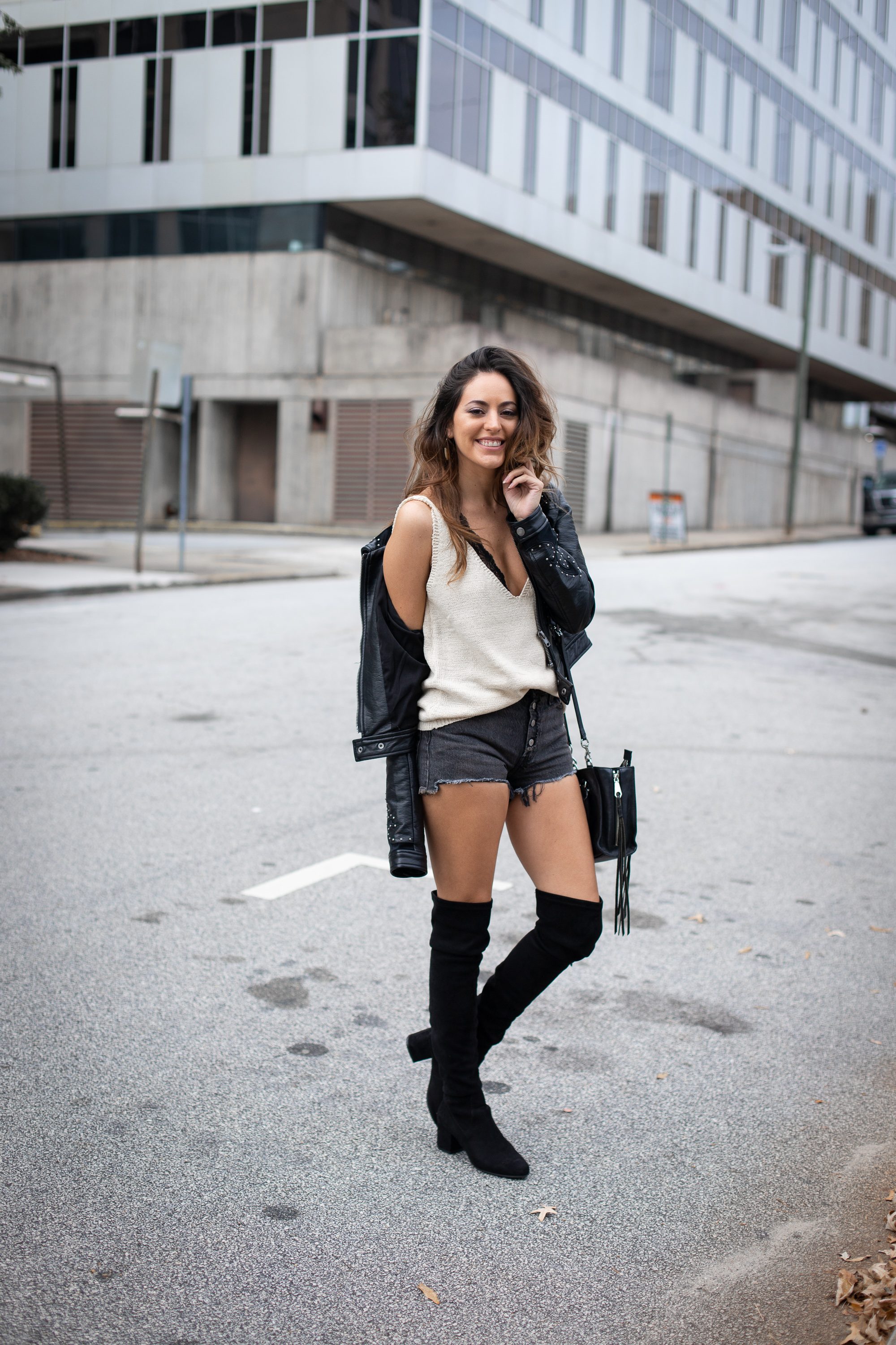 edgy city outfit ideas, how to wear otk boots, otk boots with shorts, how to wear over the knee boots with shorts, fall outfit ideas, fall style, studded faux leather jacket, Levi's 501 Shorts in black eye, aria rose styled, steve madden over the knee boots black